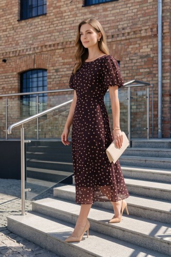 Na modelce elegancka sukienka w odcieniu burgundu w beżowe grochy, okrągły dekoltem, odcięciem po wyżej talii, krótkim, bufiastym rękawkiem zakończonym gumką, sukienka ma długość midi